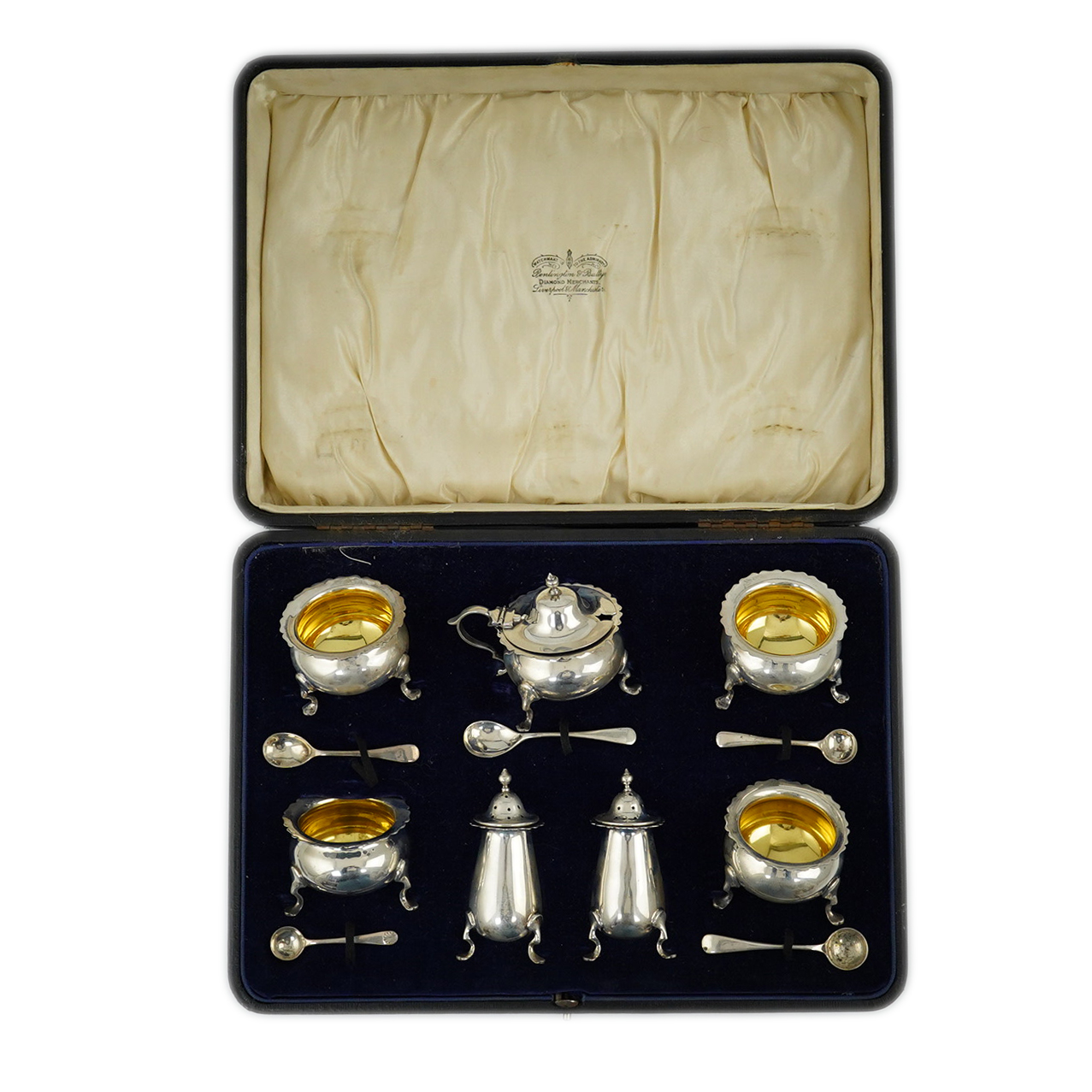 A George V cased silver seven piece condiment set by Horace Woodward & Co Ltd, Birmingham, 1918, with five associated silver condiment spoons. Condition - poor to fair